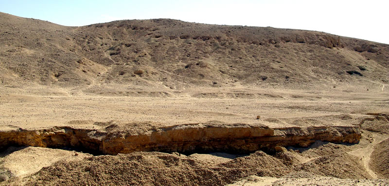 Figure 2 View (looking south) of Area H1, with openings of tombs visible along the upper portion of the cliffs and throughout the gebel.